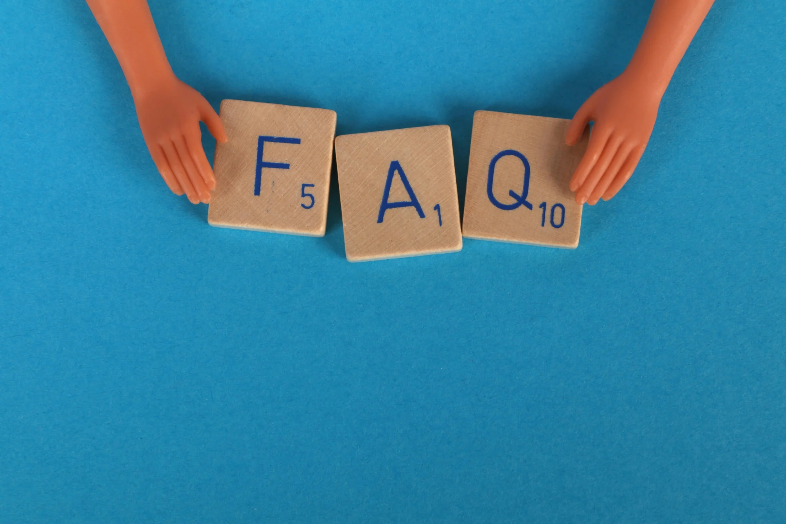 The letters "FAQ" were written using large wooden Scrabble tiles